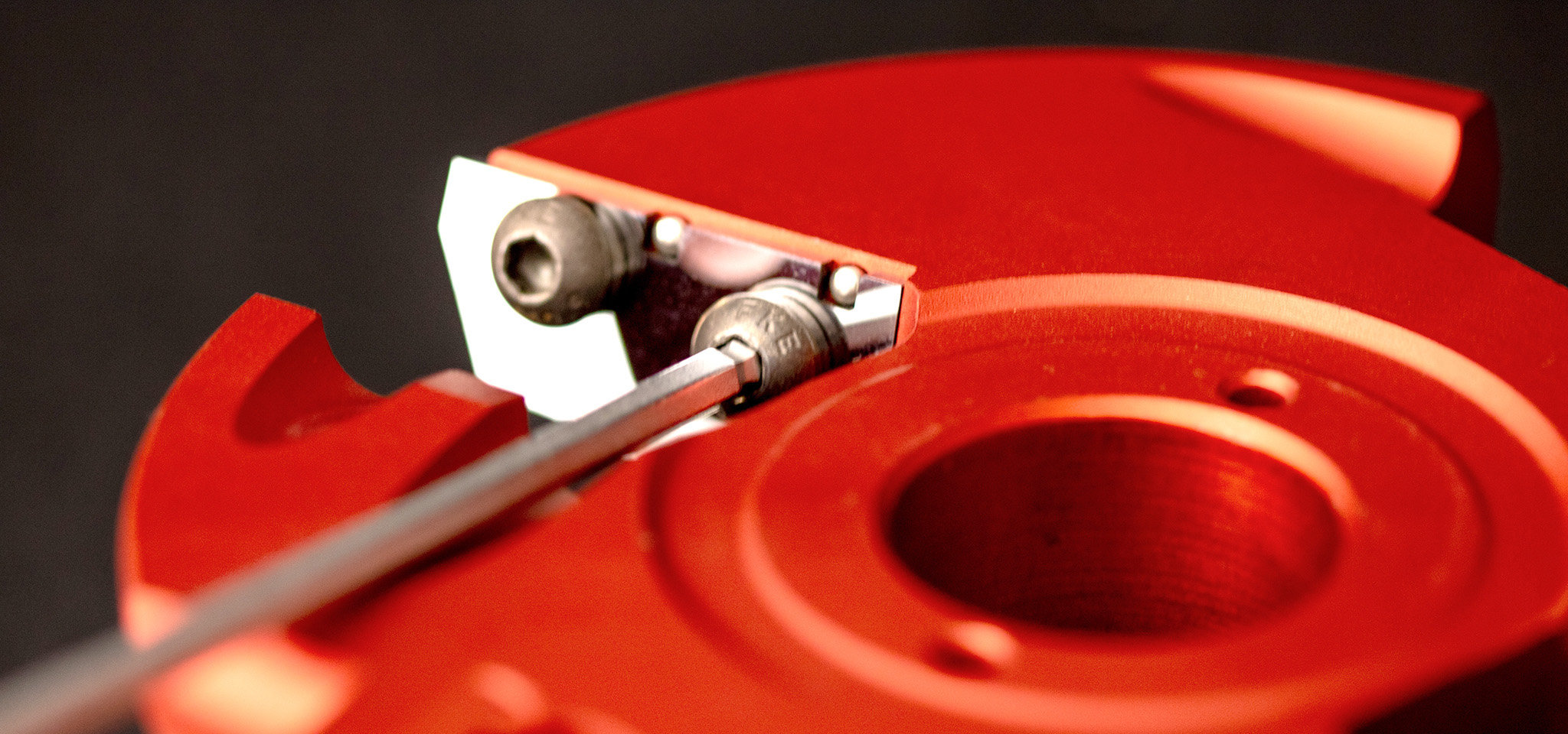 Close-up of a red Freud precision cutterhead and its cutting edges